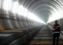 A visitor stands at the Erstfeld-Amsteg section of the NEAT Gotthard Base Tunnel October 5, 2010. With a length of 57 km (35 miles) crossing the Alps, the world's longest train tunnel should become operational at the end of 2017. REUTERS/Arnd Wiegmann (SWITZERLAND - Tags: BUSINESS CONSTRUCTION TRANSPORT TRAVEL IMAGES OF THE DAY)