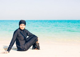 Young-woman-wearing-burkini-sitting-by-the-beach-in-dubai